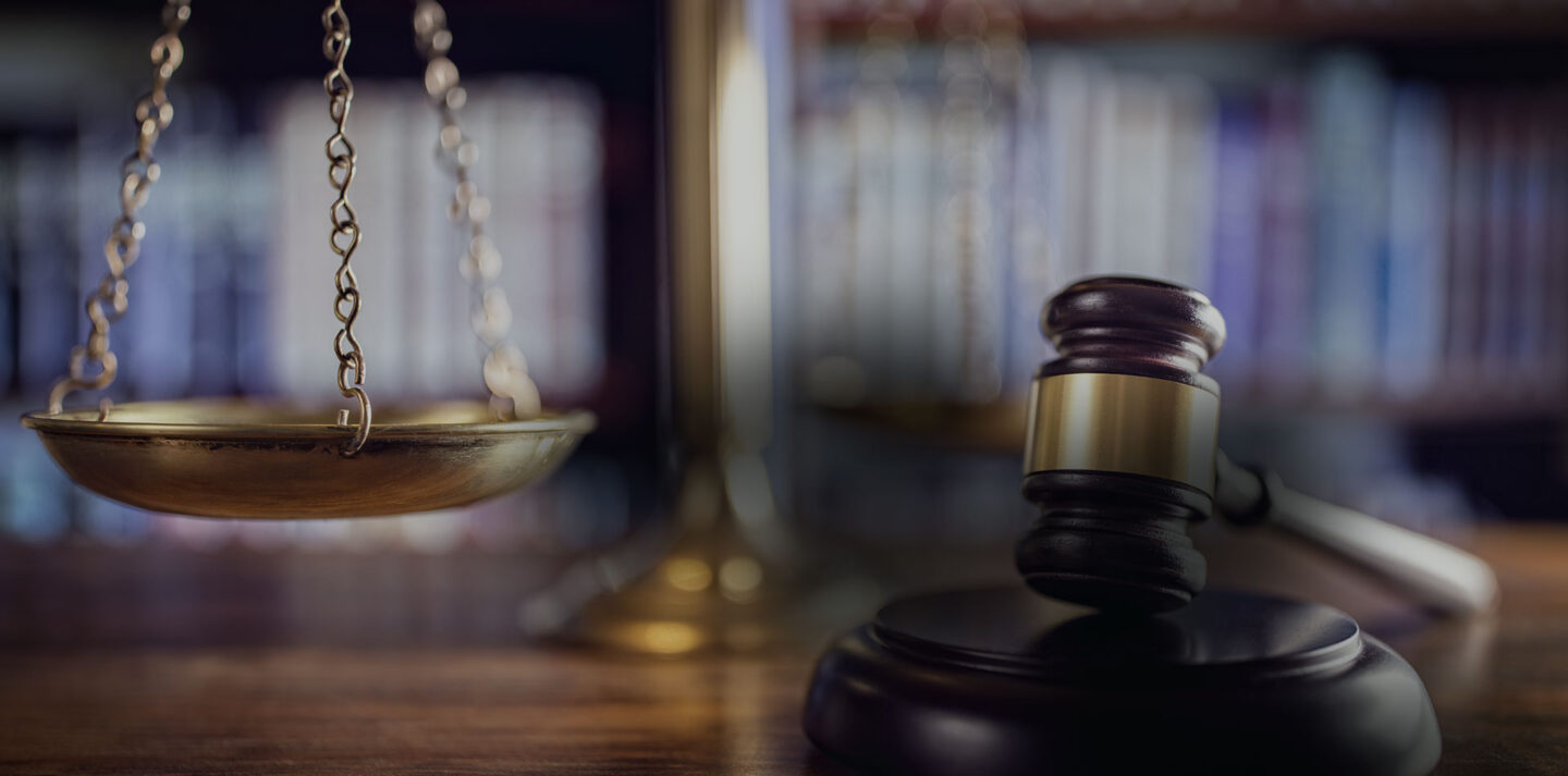 Scales of justice with gavel representing legal services in Houston for injury and criminal defense cases