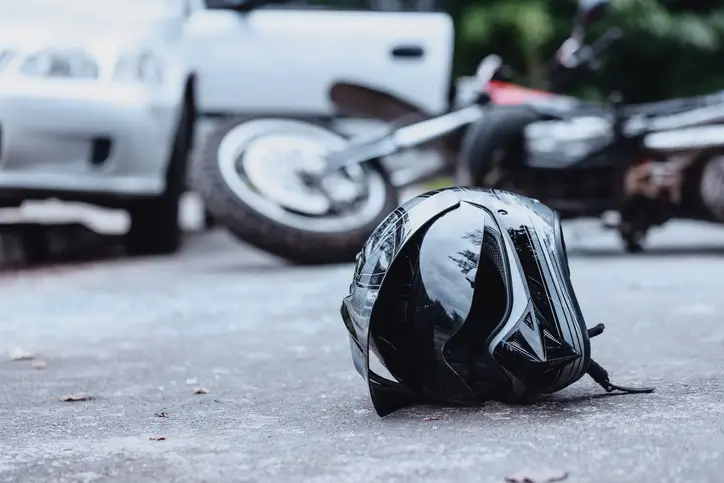Motorcycle helmet on road after crash