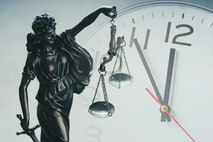 Lady Justice in front of a clock symbolizing Texas truck accident statute of limitations